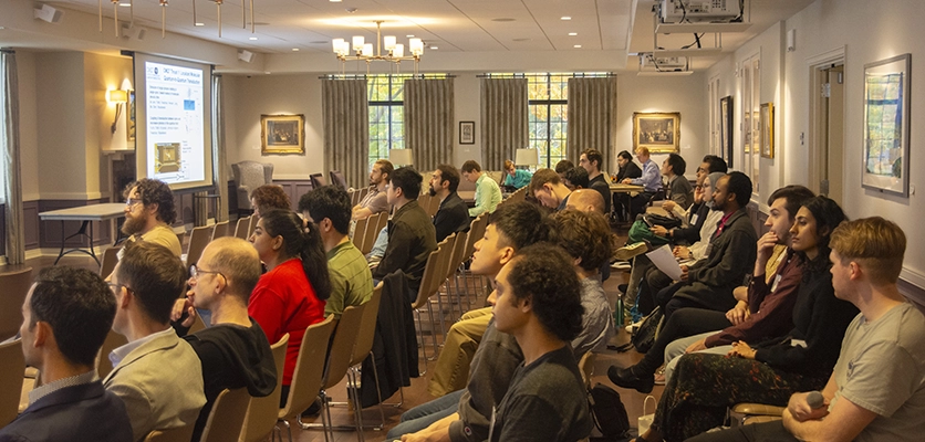 Faculty, students, and postdoctoral scholars attend a lecture at the CMQT Symposium