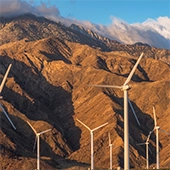 Wind turbines in front of mountains