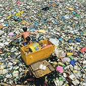 people standing in plastic landfill