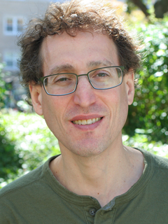 Professor Jamie Druckman - young man with curly brown hair,fair complexion, and glasses