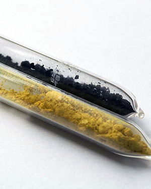 a yellow and black powdered set of chemicals inside a set of test tubes