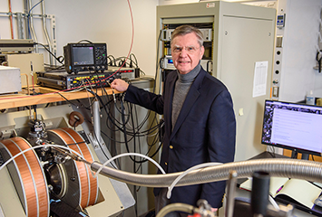 Michael R. Wasielewski standing with various pieces of equipment