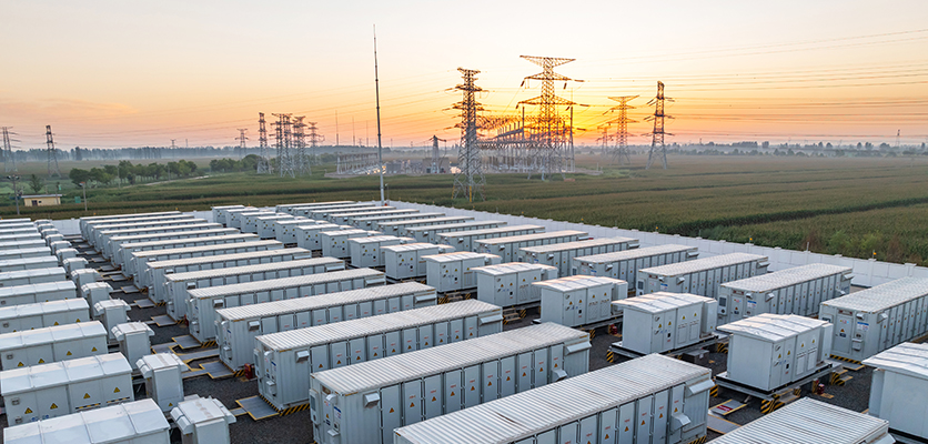 grid level storage batteries with powerlines in the background